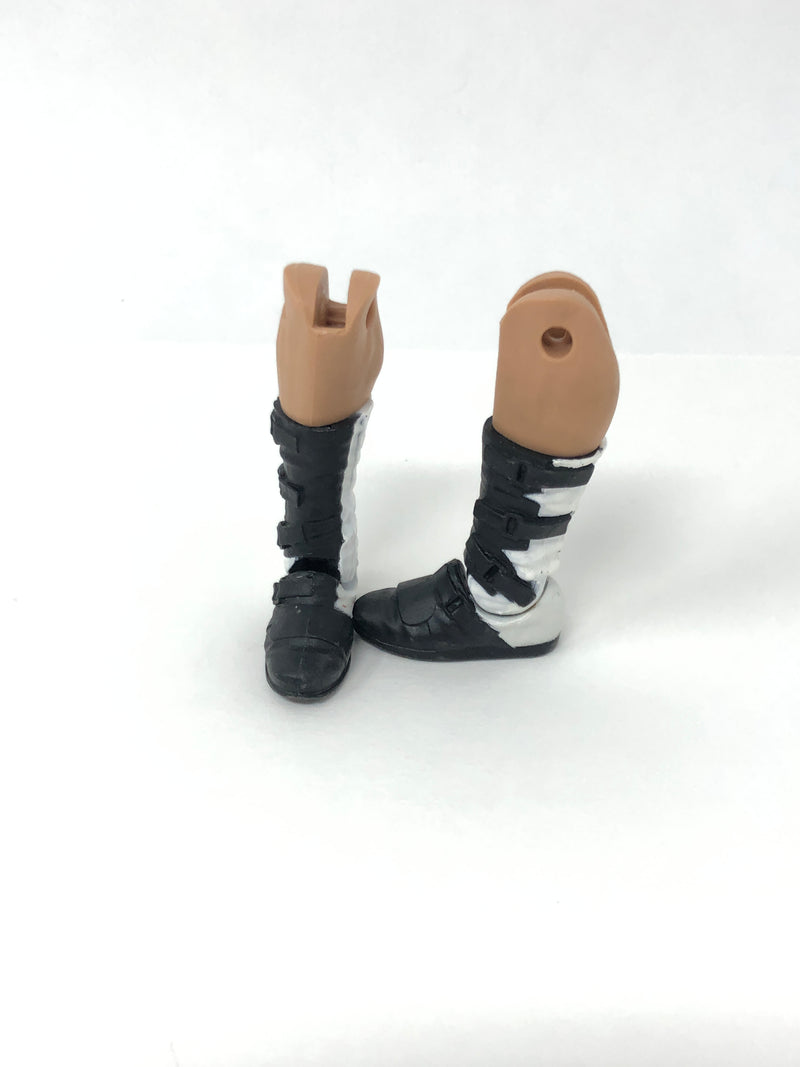 White boots with black buckles on tan legs